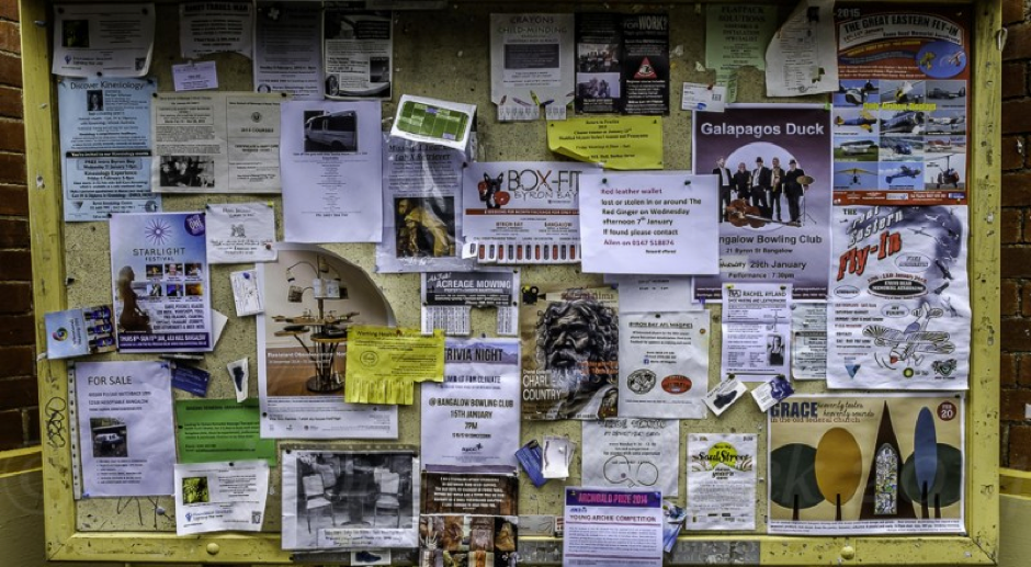 A bulletin board with lots of flyers on it. A thing of beauty.