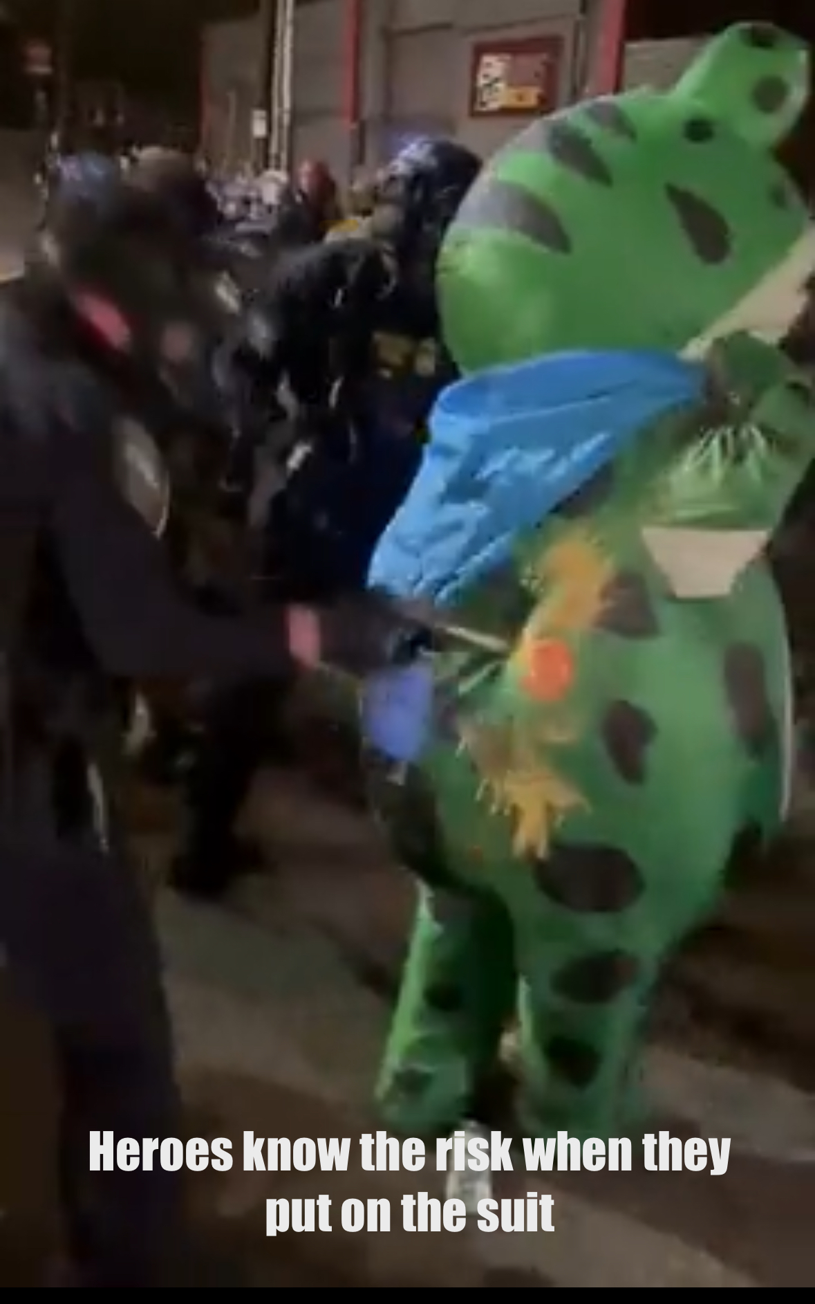 The legendary inflatable frog suit guy getting pepper sprayed for being amphibious I guess